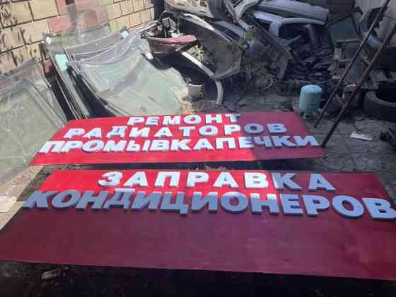 Рекламная вывеска красного цвета с объемными белыми буквами. На Бишкек